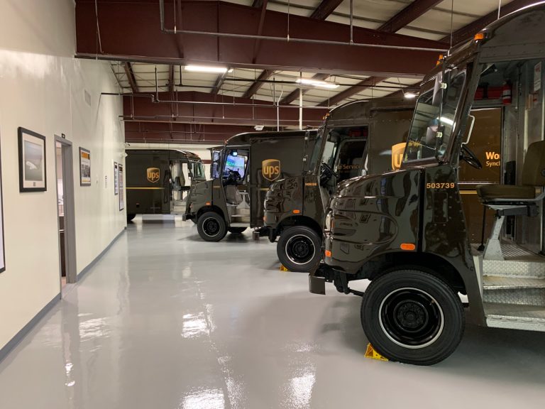 Several demonstration UPS trucks at the Integrad facility in Landover, Maryland. One of the trucks shown in the middle is equipped with computer monitors for simulation exercises. 