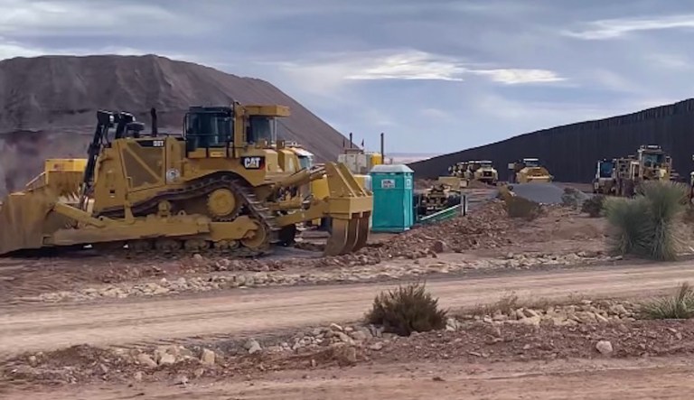 Workers in Hermanas, N.M., continue breaking down a border wall construction site following President Biden's January 20 executive order.