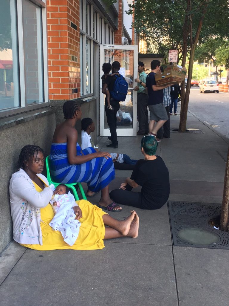 A Congolese woman sitting outside the city's migrant center.