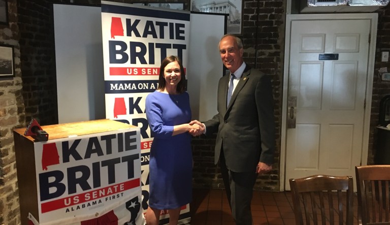Senate candidate Katie Britt (left) and Mayor Sandy Stimpson of Mobile, Alabama, shake hands.