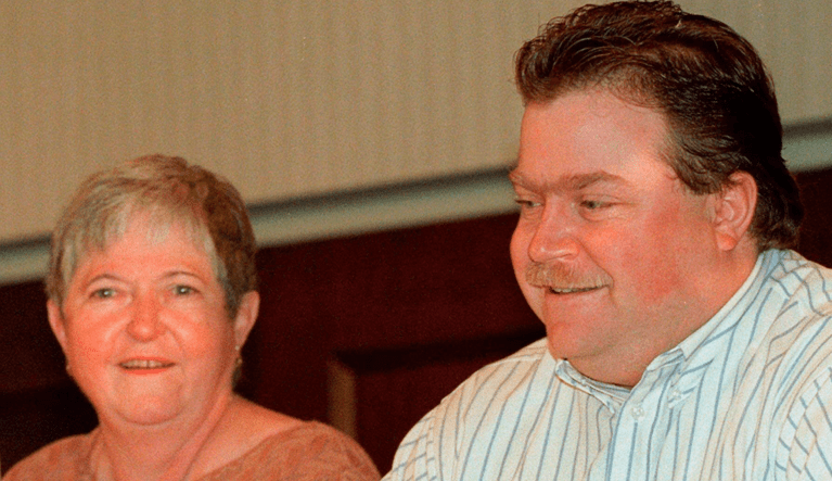 In this Oct. 28, 1996 photo, Richard Jewell, cleared of suspicion in the Olympic Park bombing, and his mother Barbara, face the media as Jewell's attorney Lin Wood addressed the press conference in Marietta, Ga. When a bomb exploded in a downtown Atlanta park midway through the 1996 Olympics, it set news reporters and law enforcement on a collision course that upended the life of a security guard, turning him from hero to villain overnight. Now, more than 20 years later, a recent book and upcoming movie explore Jewell's ordeal and the roles played by law enforcement and the media. (AP Photo/Ric Feld, File)