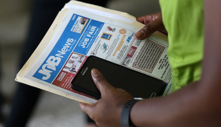 FILE - In this July 19, 2016, file photo, a job applicant attends a job fair in Miami Lakes, Fla.  President Barack Obama came in amid horrendous recession, since then has had 75 months straight months of job growth.  A smaller share of Americans are at work, this is because of dropouts, including the disabled.