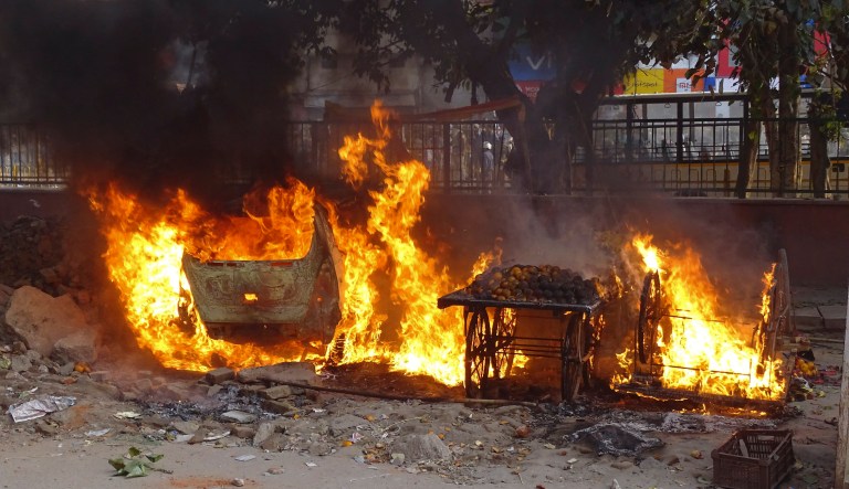 Push carts belonging to street vendors go up in flames after clashes between two groups in New Delhi, India, Monday, Feb. 24, 2020. Indian paramilitary troops used tear gas and smoke grenades to disperse a crowd of clashing protesters in New Delhi on Monday as violence broke out over a new citizenship law just ahead of U.S. President Donald Trumpâs visit to the city.