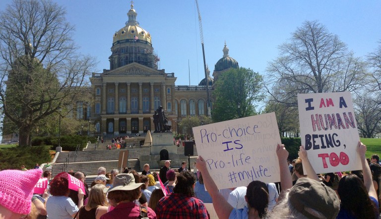 Planned Parenthood supporters rally outside the Iowa Capitol Building, Friday, May 4, 2018, in Des Moines, Iowa. The rally called for Iowa Gov. Kim Reynolds to veto a six-week abortion ban bill that would give the state the strictest abortion restrictions in the nation.
