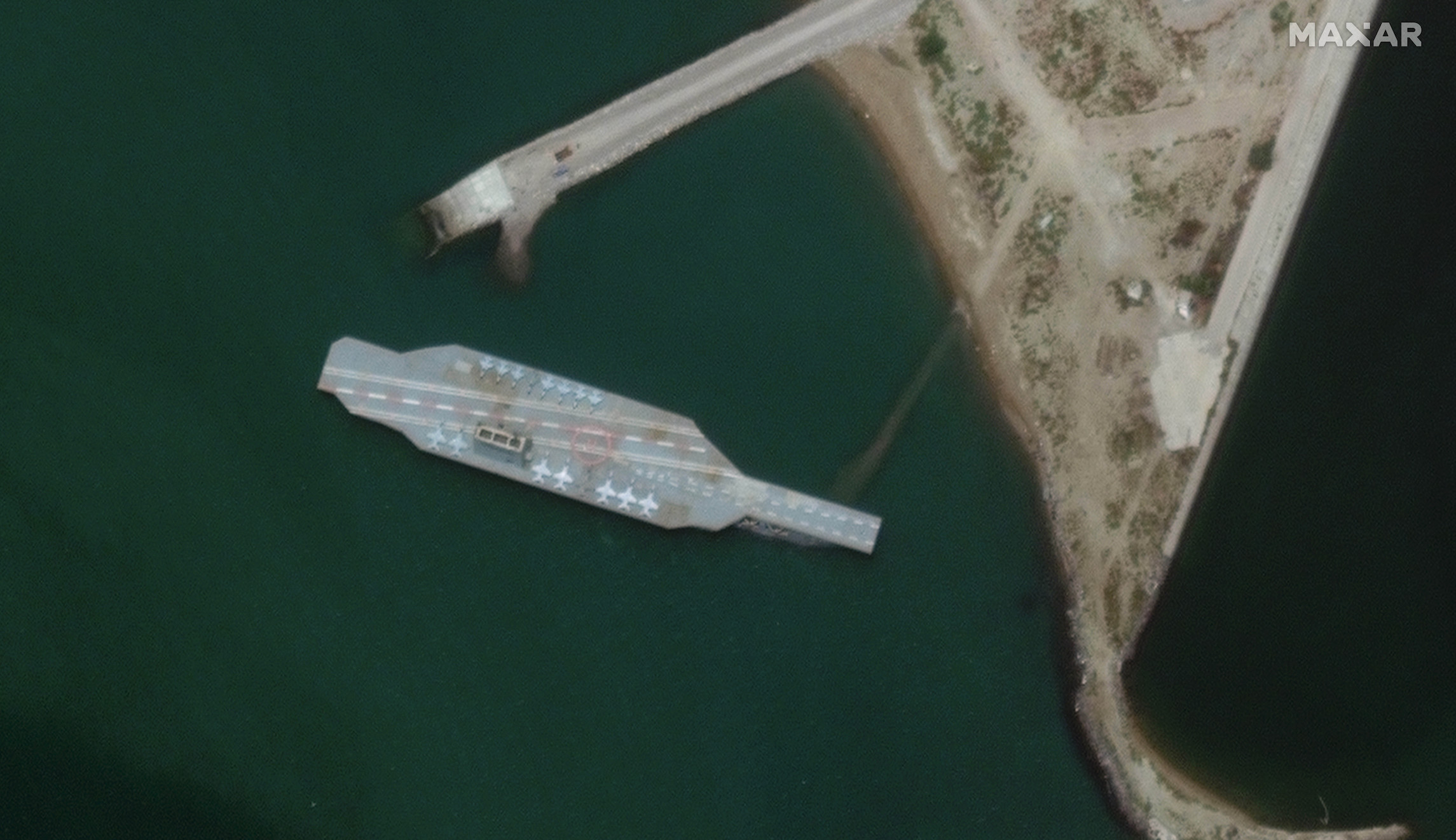 Iran appears to construct mock aircraft carrier complete with fake fighter jets