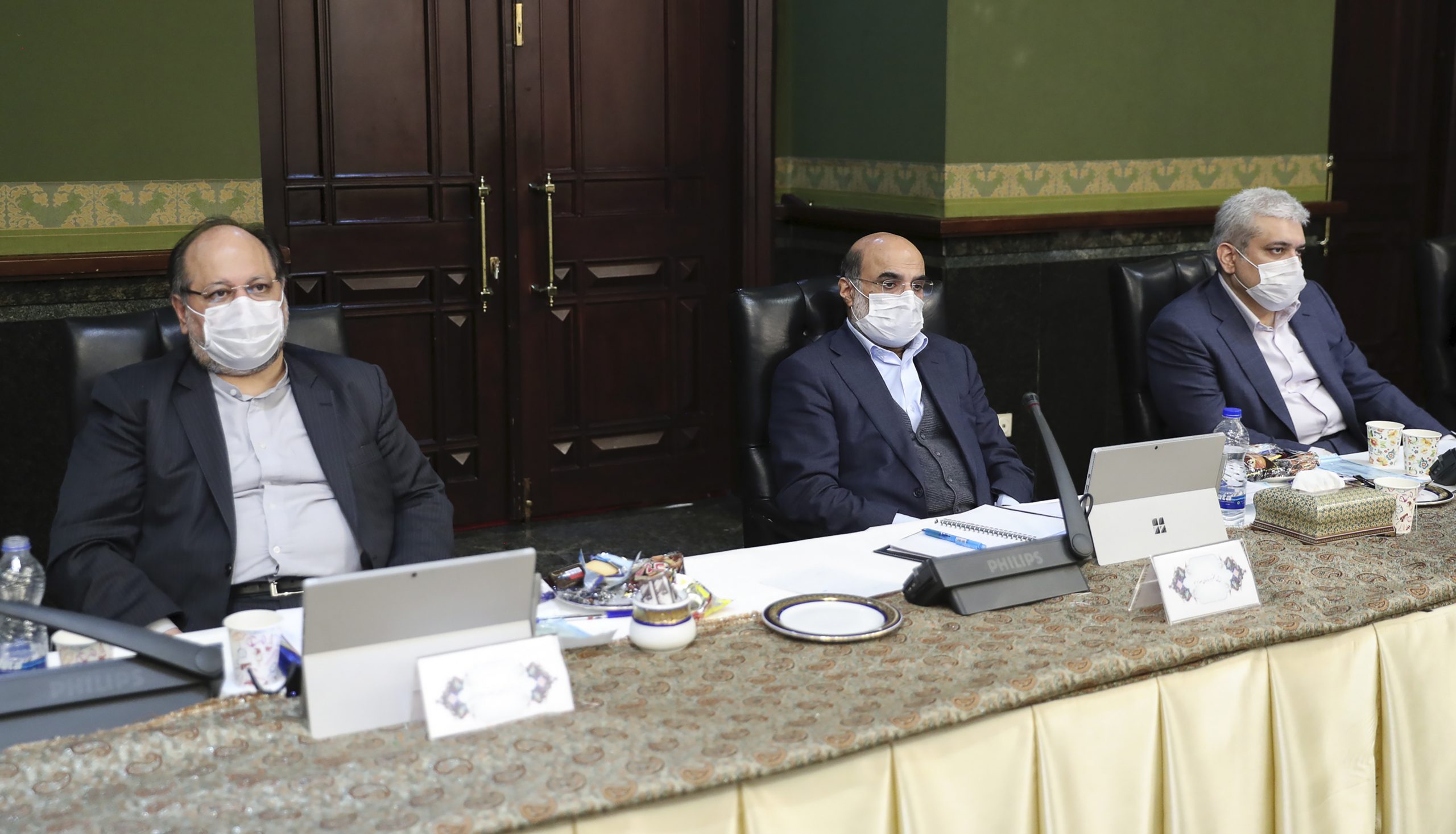In this photo released by the website of the office of the Iranian Presidency, Cabinet members wearing face masks attend their meeting in Tehran, Iran, on Wednesday.