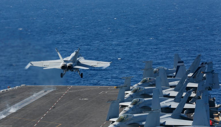 In this May 3, 2019 photo released by the U.S. Navy, An F/A-18E Super Hornet from VFA 25 launches from the flight deck of the Nimitz-class aircraft carrier USS Abraham Lincoln.