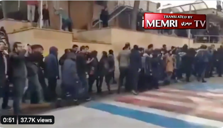 Iranian students ‘shame’ protesters for walking on US and Israeli flags