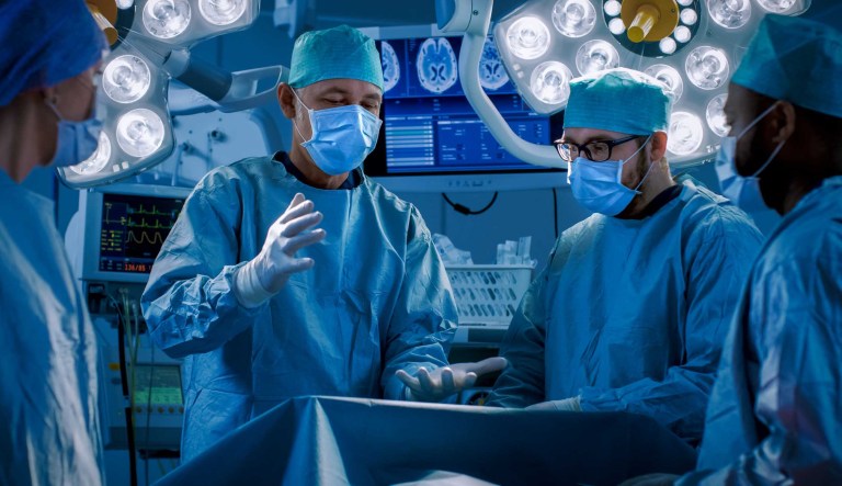Doctors and assistants working in operating room.