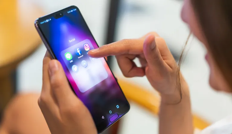 The key to stopping social media censorship is not to smash tech companies, but to amend Section 230 A woman using her phone and social media apps.