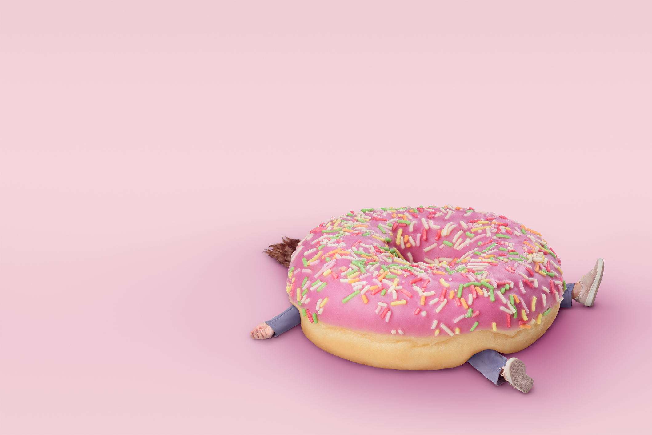 Girl with  donut. Fast food concept, overweight. Minimal pink background with copy space