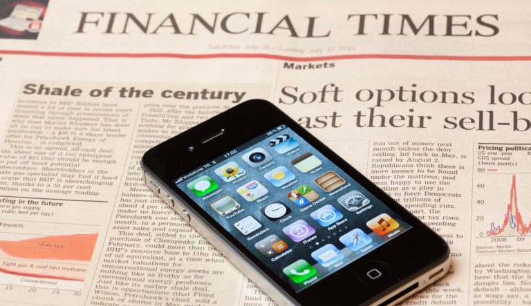 Iphone 4S on pages of Financial Times newspaper.