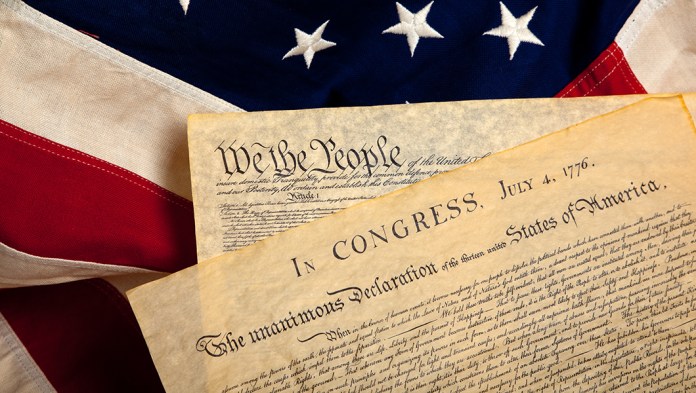United States Constitution and Declaration of Independence on a flag background.