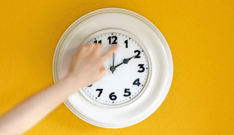 Daylight saving clock being turned.