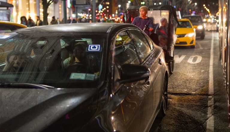 An Uber vehicle in New York in June 2017. The largest U.S. city is capping the number of vehicles operated by ride-hailing services like Uber for one year.