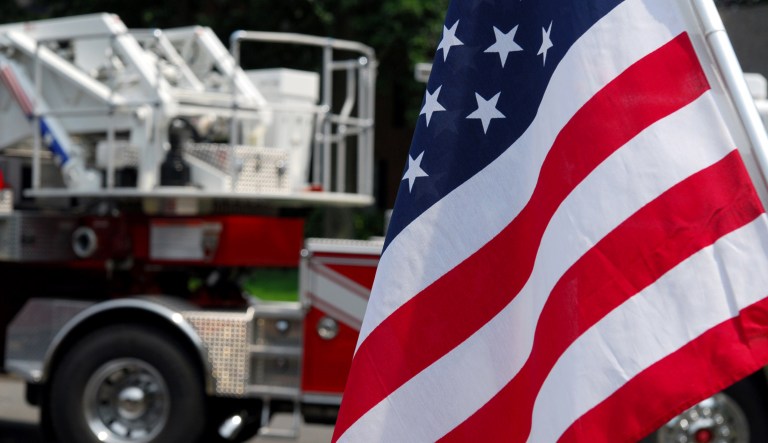 A U.S. flag is seen in front of a fire truck.