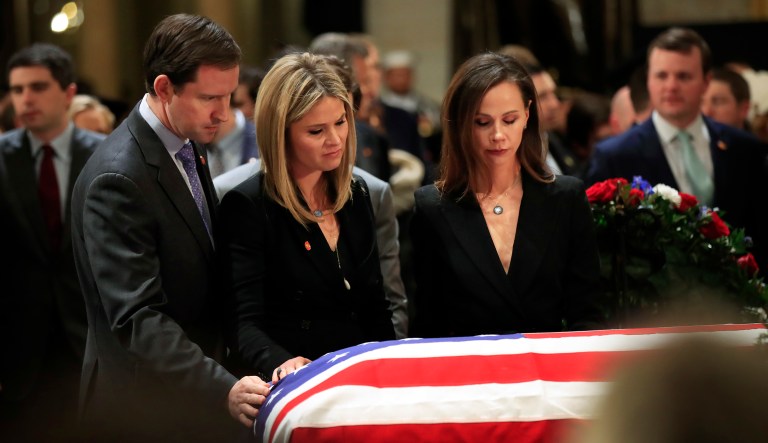 Jenna Bush Hager, center, and her husband Henry Hager, left, and her twin sister Barbara Bush, right, pay their respect to their grandfather, former President George H.W. Bush as he lie in state at the U.S. Capitol in Washington, Tuesday, Dec. 4, 2018.