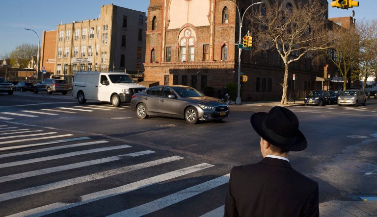 In this April 26, 2018 file photo, a Jewish boy walks to a yeshiva in the Brooklyn borough of New York.