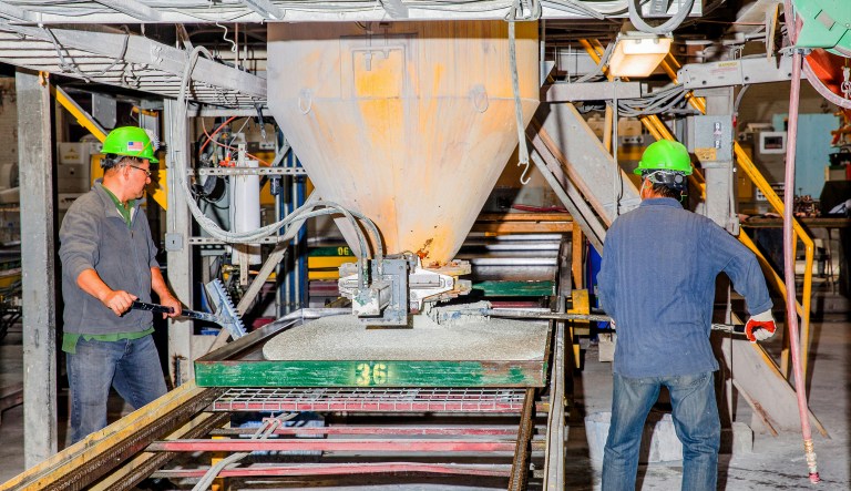 Workers pour materials used for making glass countertops at the IceStone manufacturing facility in the Brooklyn borough of New York, U.S., on Monday, Nov. 14, 2016. The Federal Reserve Bank of New York is scheduled to release the empire state manufacturing figures on November 15.