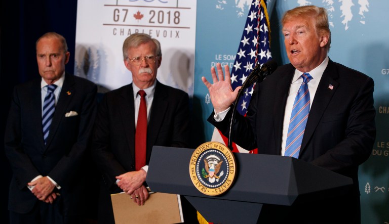 White House chief economic adviser Larry Kudlow, left, and National Security Adviser John Bolton look on as President Donald Trump speaks during a news conference at the G-7 summit, Saturday, June 9, 2018, in Charlevoix, Canada.