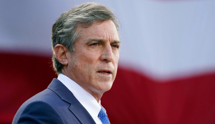 Delaware Gov. John Carney speaks at the Major Joseph R. "Beau" Biden III National Guard/Reserve Center, Tuesday, Jan. 19, 2021, in New Castle, Del. 
