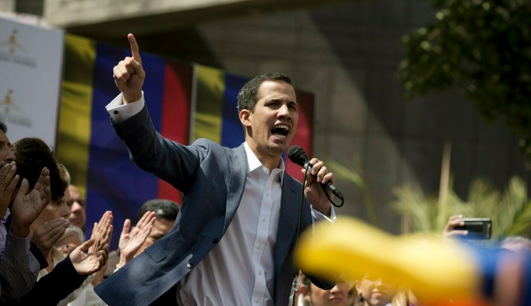 In this Jan. 11, 2019 photo, Juan Guaido, President of the Venezuelan National Assembly delivers a speech during a public session with opposition members, at a street in Caracas, Venezuela. The head of Venezuela's opposition-run congress says that with the nation's backing he's ready to take on Nicolas Maduro's presidential powers and call new elections.