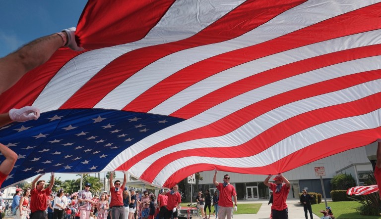 Participants carry an American flag during the 4th of July parade in Santa Monica, Calif., on Tuesday, July 4, 2017.