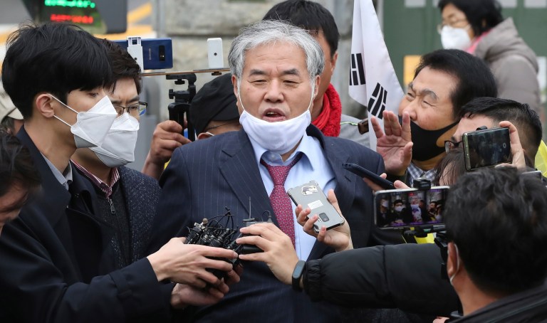 In this April 20, 2020 photo, Sarang Jeil Church pastor Jun Kwang-hun speaks outside a detention center in Uiwang, South Korea. Jun who has been a bitter critic of the country's president has tested positive for the coronavirus, health authorities said Monday, Aug. 17, two days after he participated in an anti-government rally in Seoul that drew thousands.                                                                