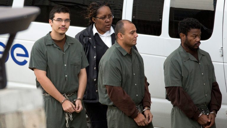 FILE - In a Thursday, Dec. 14, 2017 file photo, eighteen-year-old Kaan Sercan Damlarkaya, left, is brought in for hearing at the Federal Court in Houston. Prosecutors say 20-year-old Damlarkaya of Houston pleaded guilty Monday, July 8, 2019 to trying to join the Islamic State group.  
