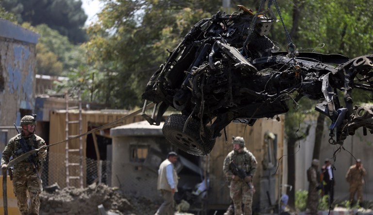 Resolute Support forces remove a damaged vehicle after a car bomb explosion in Kabul, Afghanistan, Thursday, Sept. 5, 2019.
