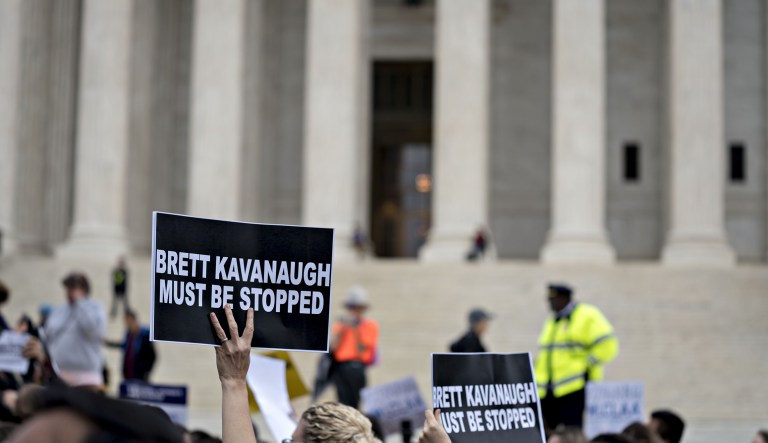 A demonstrator holds a "Brett Kavanaugh Must Be Stopped" sign outside the U.S. Supreme Court in Washington, D.C., U.S., on Monday, Sept. 24, 2018. President Donald Trump said he backs Supreme Court nominee Kavanaugh "all the way" and dismissed as "unsubstantiated statements" new sexual misconduct allegations as the nomination is at risk of unraveling.