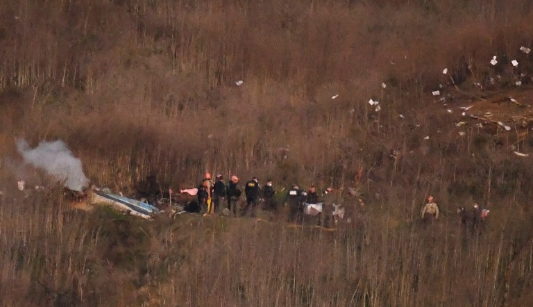 A body is moved from the scene of a helicopter crash that killed former NBA basketball player Kobe Bryant in Calabasas, Calif., Sunday, Jan. 26, 2020.