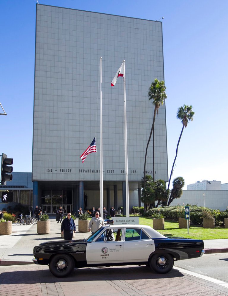 A 1969 Plymouth Belvedere police patrol car is parked in front of Los Angeles Police Department's Parker Center, the iconic building that housed Los Angeles police operations for nearly 60 years.