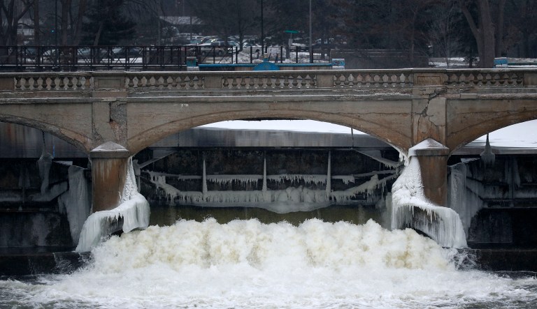 FILE - This Jan. 21, 2016 file photo shows the Flint River near downtown Flint, Mich. City leaders are floating a shockingly high price to replace the city's water infrastructure damaged after the stateâs disastrous decision in 2014 to use the Flint River as the cityâs drinking water source without adding a chemical to control corrosion, which caused high levels of chloride from the river to react with iron in the pipes, causing lead to leach into water for a year and a half and contributing to a spike in child lead poisoning before city and state officials fully acknowledged the problem.