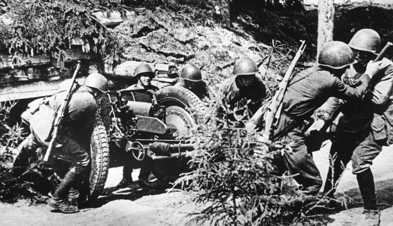 A group of artillerymen of the Soviet Red Army is seen as they bring their large-caliber gun in position, at the front line around the besieged city of Leningrad, in July 1942. 