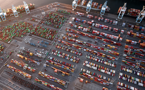 In an aerial view, container ships and shipping containers are seen at the Port of Los Angeles on September 20, 2021 near Los Angeles, California.