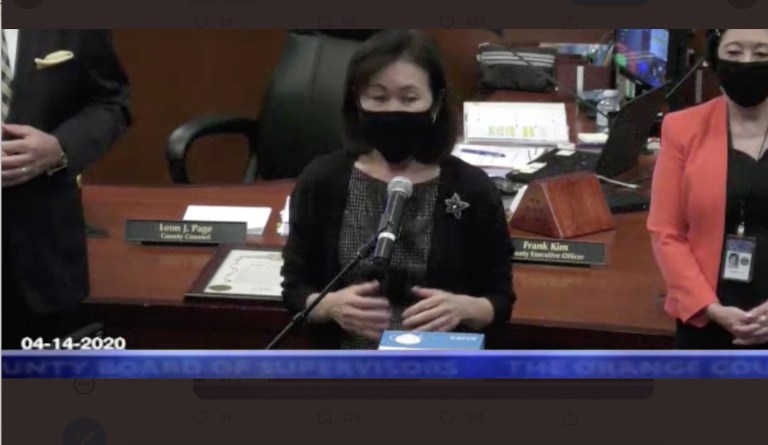 Orange County supervisor Michelle Steel dons a mask during a county board meeting