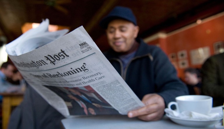 A man reads the Washington Post at Tryst coffee shop in Washington, D.C., on Feb 25, 2009.