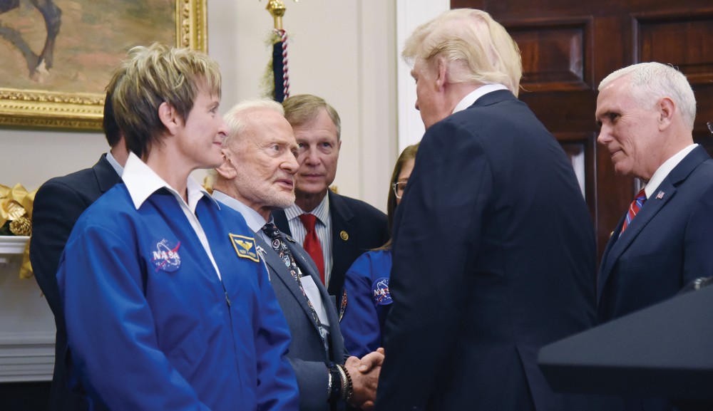 Former astronaut Buzz Aldrin, center left, has pressed for more NASA funding. And as a result of President Trump's space policy, House and Senate lawmakers have for now agreed to bolster NASA spending.