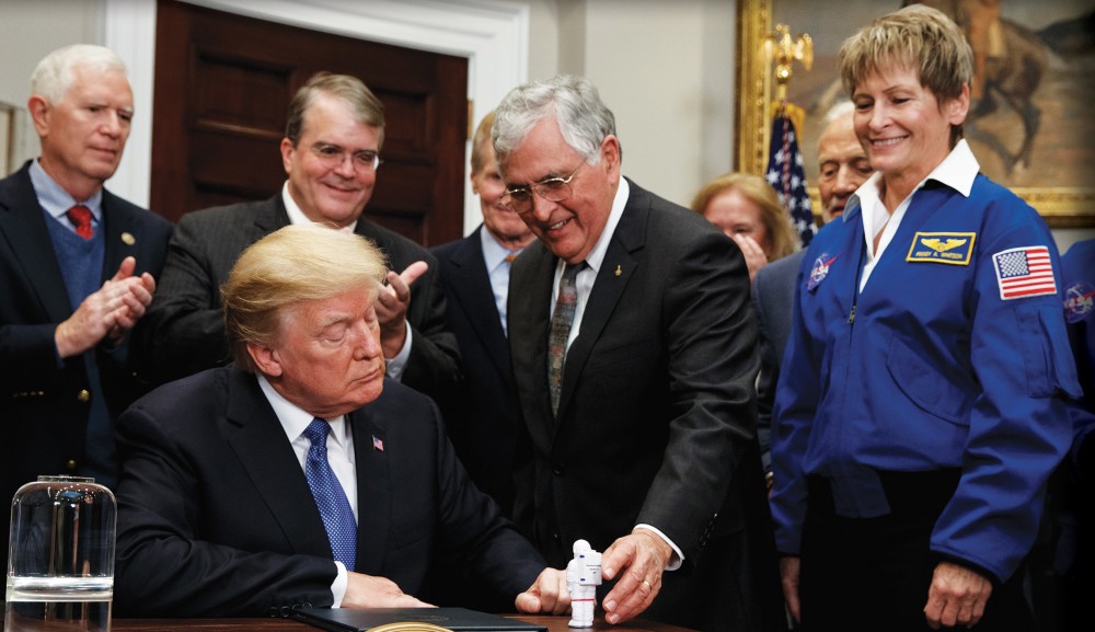 Harrison “Jack” Schmitt, the last living crew member of the Apollo 17 mission and one of only four living astronauts who have walked on the moon, hands a figurine to President Trump after he signed a space policy directive to send American astronauts back to the moon and ultimately Mars.