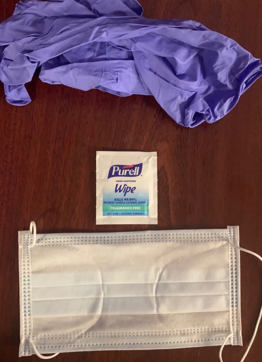 A Purell wipe, a mask, and gloves issued to an NYPD officer are seen.