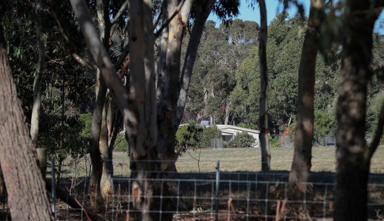A property is seen from a police roadblock where police are investigating the death of seven people in a suspected murder-suicide in Osmington, east of Margaret River, 162 miles (260 kms.) south west of Perth, Friday, May 11, 2018. Seven people including four children were found dead with gunshot wounds at a rural property in southwest Australia in what could be the country's worst mass shooting in 22 years.