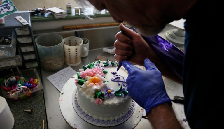 In this March 10, 2014 photo, Masterpiece Cakeshop owner Jack Phillips decorates a cake inside his store, in Lakewood, Colo. Phillips is appealing a recent ruling against him in a legal complaint filed with the Colorado Civil Rights Commission by a gay couple he refused to make a wedding cake for, based on his religious beliefs.