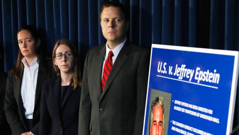 Assistant U.S. Attorney Maurene Comey, left, listens during a news conference, in New York, Monday, July 8, 2019.