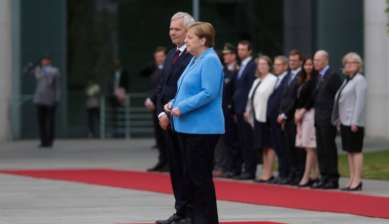 German Chancellor Angela Merkel and Prime Minister of Finland Antti Rinne listen to the national anthems at the chancellery in Berlin, Germany, Wednesday, July 10, 2019.