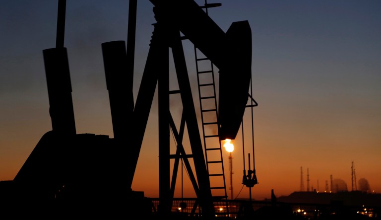 An oil pump works at sunset on Jan. 18, 2016, in the desert oil fields of Sakhir, Bahrain.