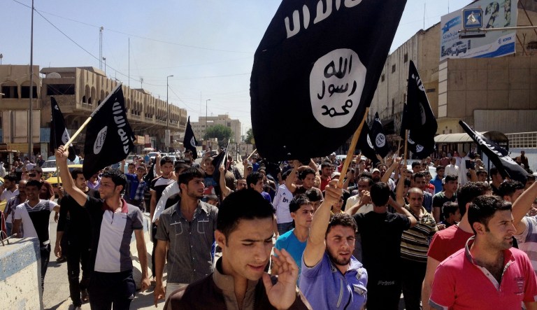 Demonstrators carry al Qaeda flags in front of the provincial government headquarters in Mosul, northwest of Baghdad, Iraq, on June 16, 2014.