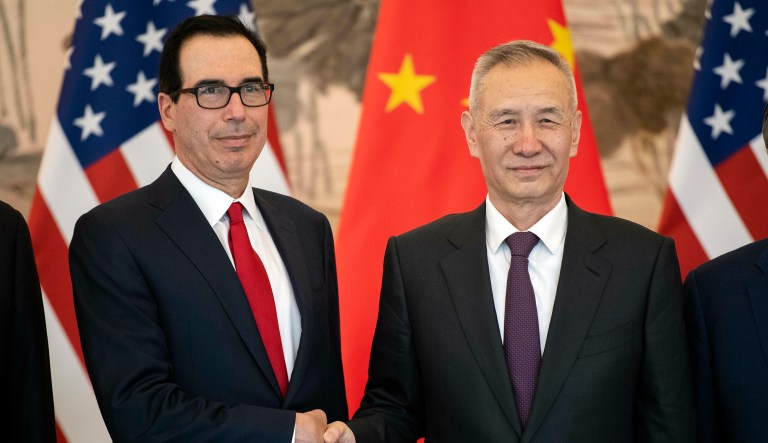 China's Vice Premier Liu He, right, shakes hands with U.S. Treasury Secretary Steven Mnuchin as they pose for a group photo at Diaoyutai State Guesthouse in Beijing Friday, March 29, 2019.