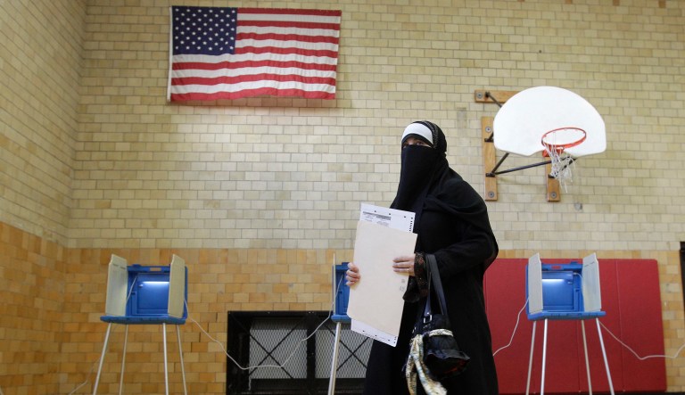 Tahani Ahmed submits her ballot after voting at Lowrey School in Dearborn Mich., Tuesday, Nov. 2, 2010. 