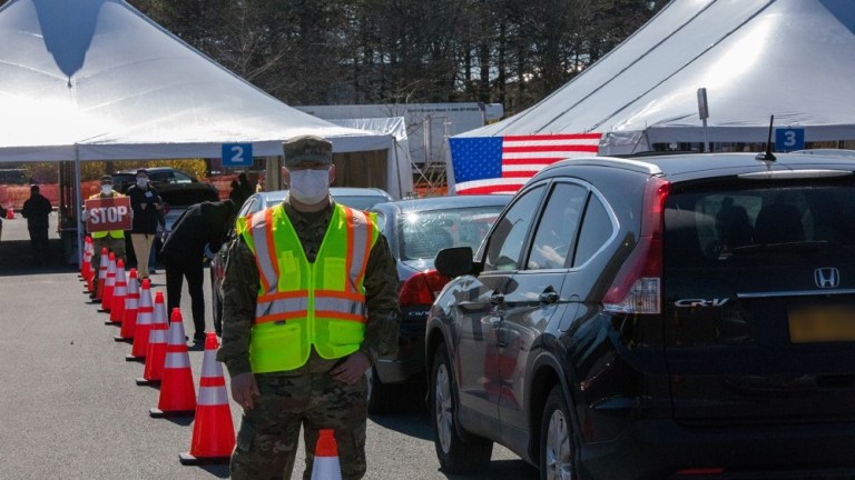 Sergeant Geoff Maher assists with traffic control at the Albany Covid-19 drive-through test site in support of the New York National Guardâs coronavirus outbreak response.